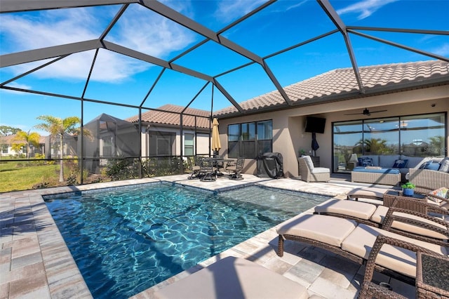 outdoor pool featuring an outdoor living space, a lanai, a ceiling fan, and a patio area