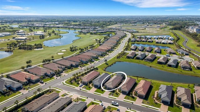 aerial view with a residential view, a water view, and view of golf course