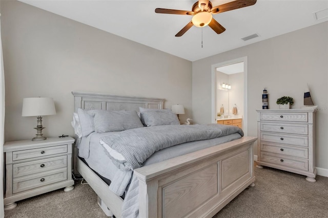 bedroom with visible vents, light colored carpet, a ceiling fan, and connected bathroom