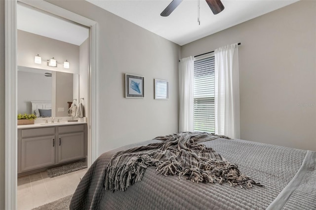 bedroom featuring a sink, light tile patterned flooring, ensuite bathroom, and ceiling fan