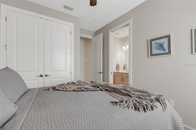 bedroom featuring visible vents, a closet, ensuite bath, and a ceiling fan