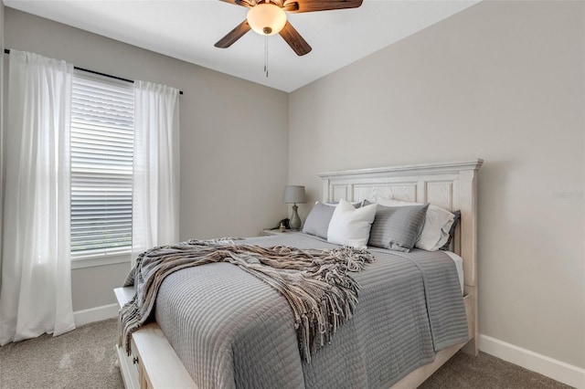 bedroom featuring light colored carpet, baseboards, and ceiling fan