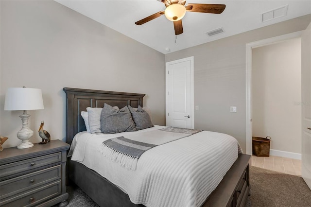 bedroom featuring visible vents, baseboards, ceiling fan, and tile patterned flooring