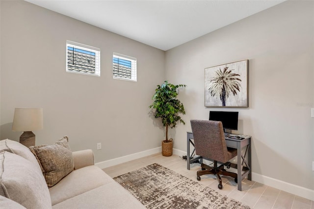 office with baseboards and light wood-style flooring