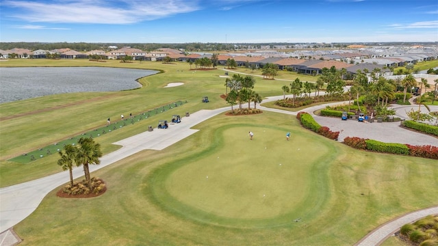 birds eye view of property featuring a residential view, view of golf course, and a water view