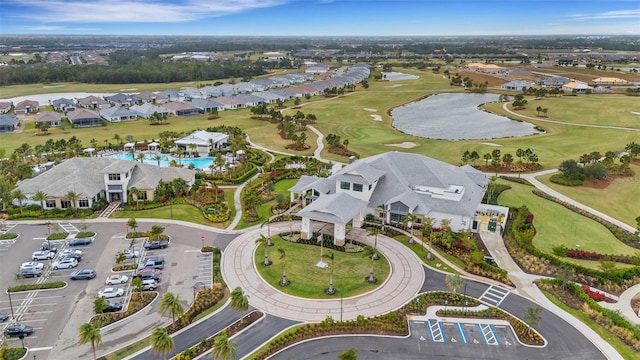 aerial view featuring a residential view, golf course view, and a water view