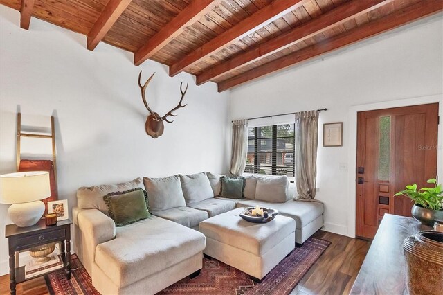 living area with beam ceiling, wood ceiling, and dark wood finished floors