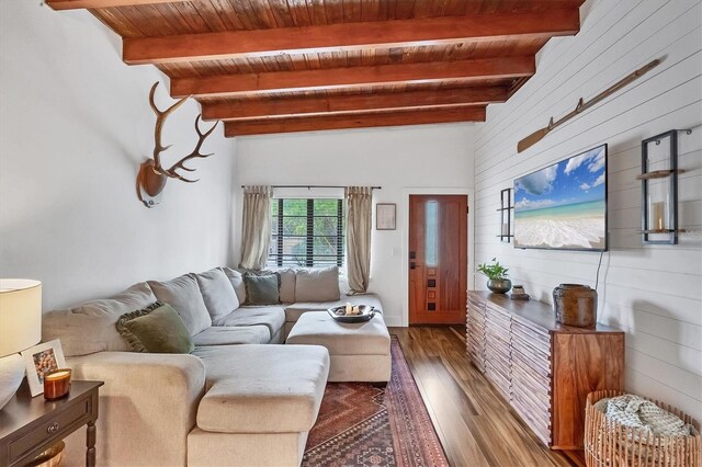 living room with beam ceiling, wooden walls, wood ceiling, and dark wood-style flooring