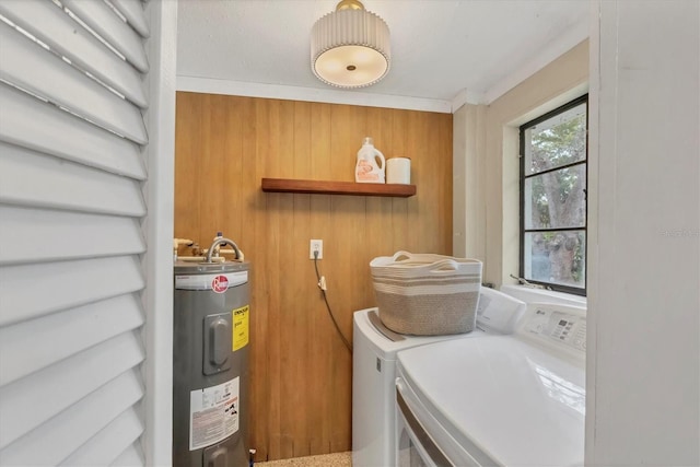 clothes washing area featuring laundry area, independent washer and dryer, and electric water heater