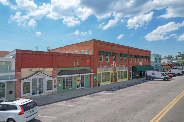 view of building exterior with uncovered parking