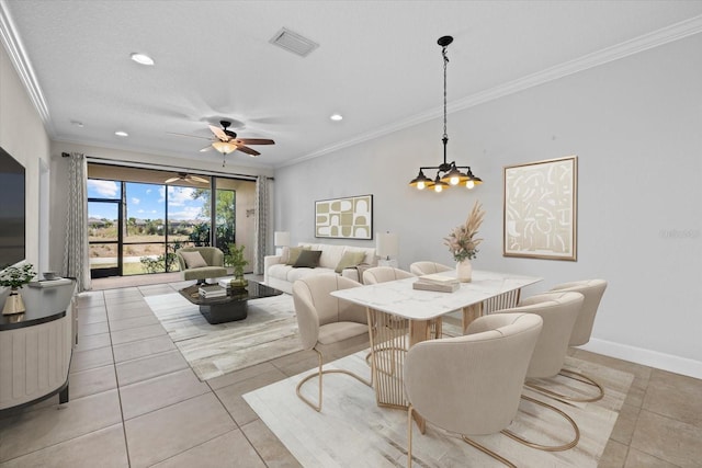 dining area featuring light tile patterned floors, visible vents, crown molding, and baseboards