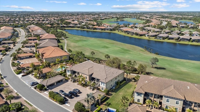 aerial view featuring a residential view, view of golf course, and a water view