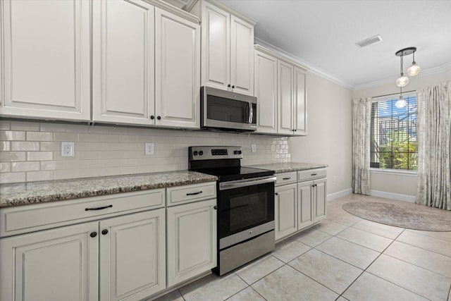 kitchen featuring visible vents, light tile patterned flooring, ornamental molding, appliances with stainless steel finishes, and tasteful backsplash