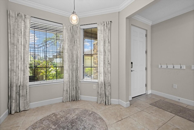 entrance foyer with tile patterned flooring, crown molding, and baseboards