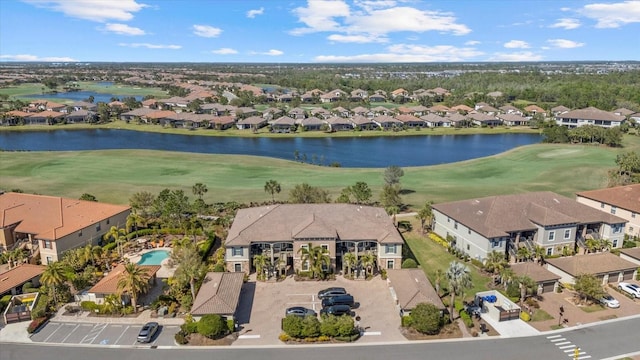 bird's eye view featuring a residential view, view of golf course, and a water view