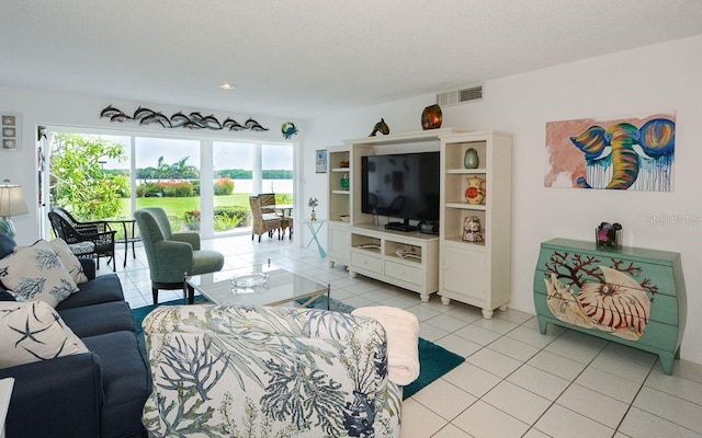 living room with light tile patterned floors and visible vents