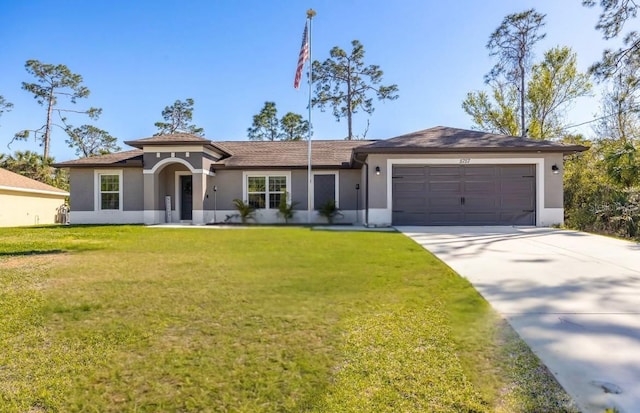 view of front of property with stucco siding, an attached garage, concrete driveway, and a front lawn