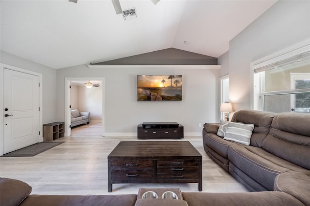 living area featuring light wood-type flooring, visible vents, baseboards, ceiling fan, and vaulted ceiling