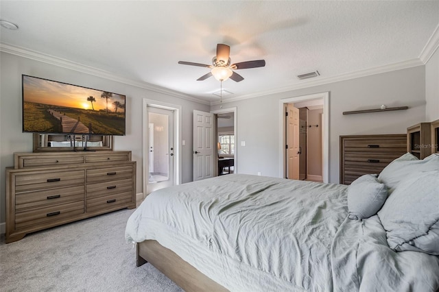 bedroom with visible vents, ceiling fan, ornamental molding, light colored carpet, and connected bathroom