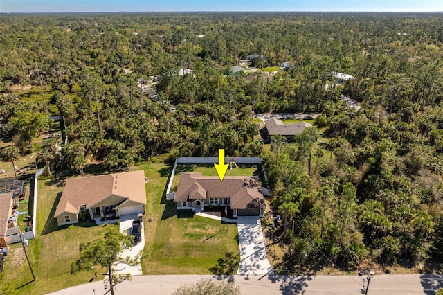 birds eye view of property with a forest view