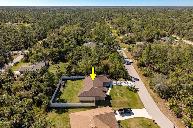 birds eye view of property with a view of trees