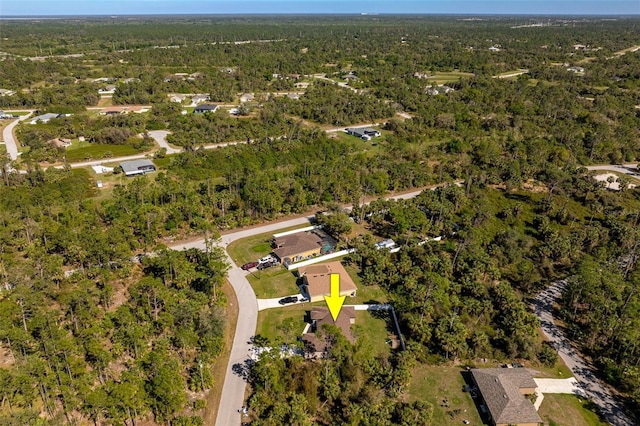 drone / aerial view with a wooded view