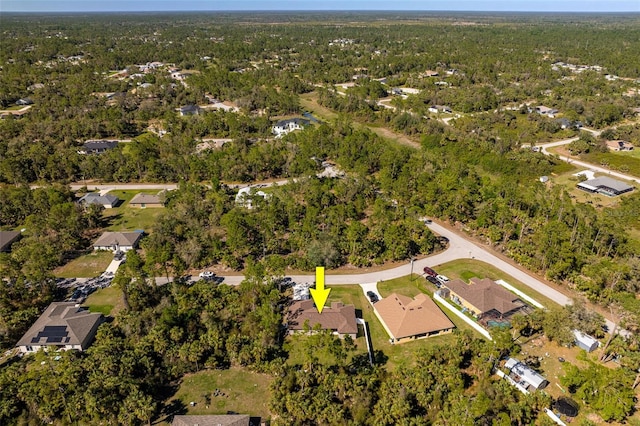 aerial view featuring a forest view and a residential view