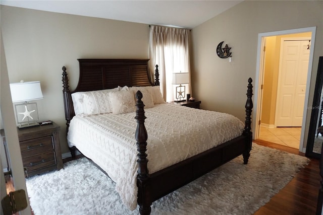 bedroom featuring wood finished floors and baseboards