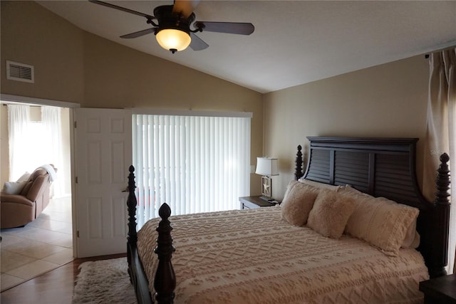 bedroom with visible vents, lofted ceiling, and ceiling fan