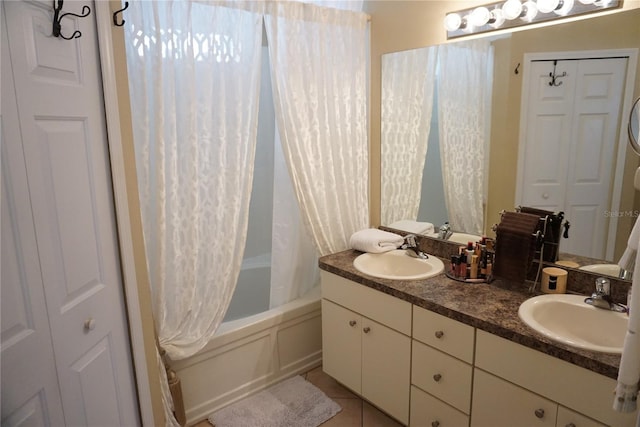 full bath featuring a sink, shower / bath combo, double vanity, and tile patterned flooring