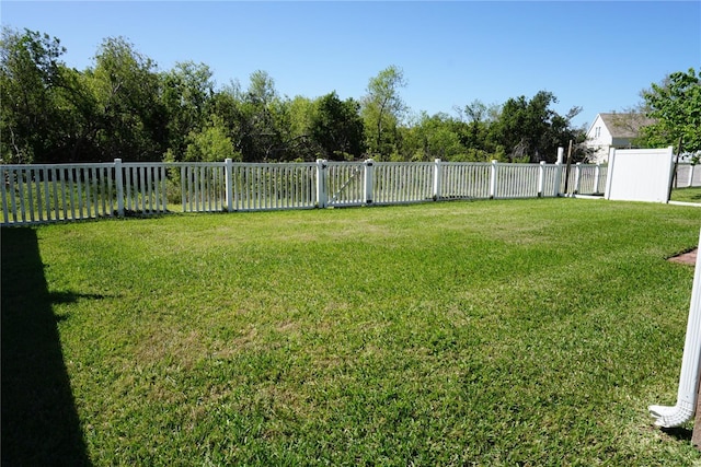 view of yard with a fenced backyard