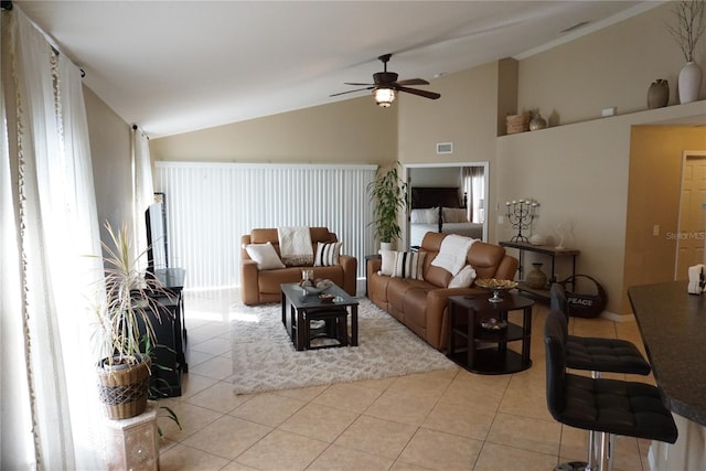 living room featuring light tile patterned floors, visible vents, lofted ceiling, and a ceiling fan