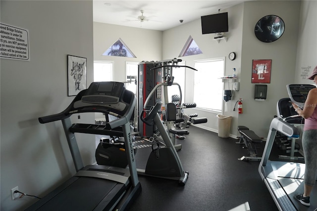 workout area with baseboards and a ceiling fan