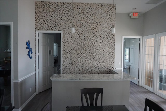 kitchen with light stone counters and wood finished floors