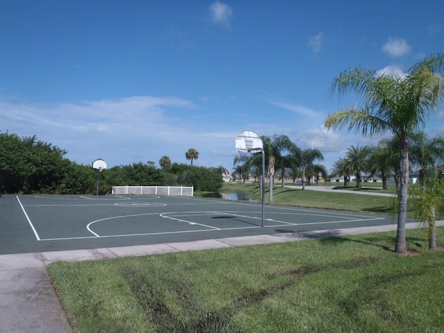 view of basketball court with community basketball court and a yard