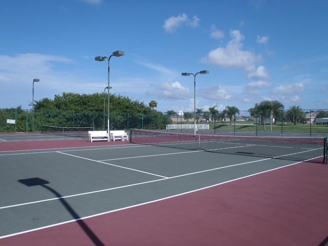 view of tennis court with fence