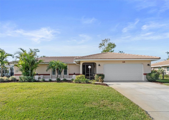 128 Da Vinci Dr, Nokomis, FL 34275 - view of front of home featuring a front yard, driveway, an attached garage, stucco siding, and a tile roof