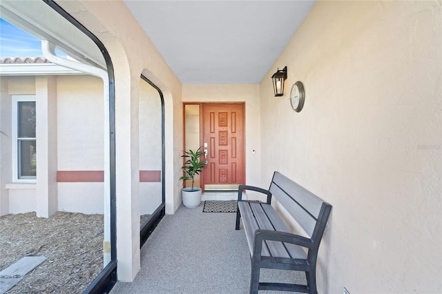 entrance to property featuring stucco siding