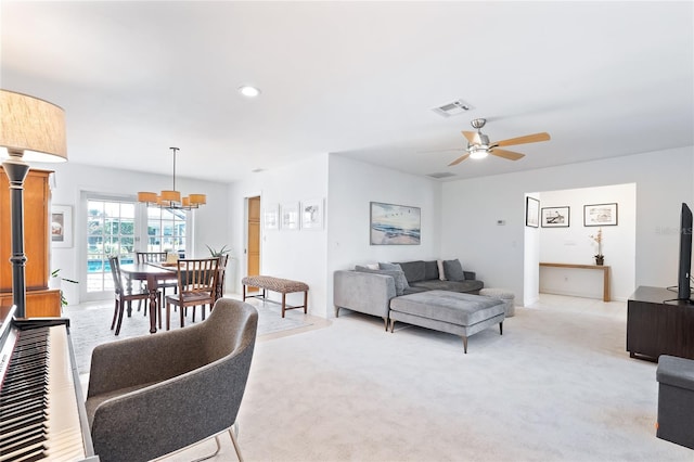 living area featuring recessed lighting, visible vents, light colored carpet, and a ceiling fan