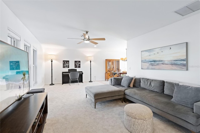 living area with baseboards, light colored carpet, visible vents, and ceiling fan