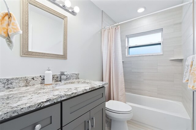 full bath featuring toilet, shower / bath combo, and vanity