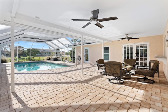 outdoor pool featuring a lanai, french doors, a ceiling fan, and a patio