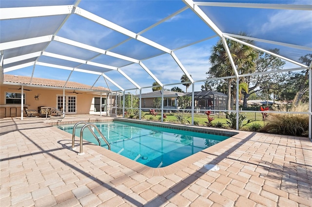 pool featuring a patio area, a lanai, and a ceiling fan