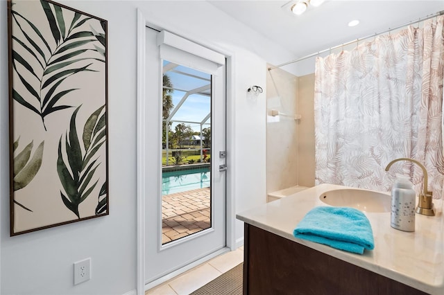 bathroom with a shower with curtain, vanity, and tile patterned flooring