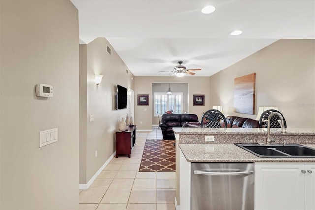 kitchen with light tile patterned floors, a ceiling fan, a sink, dishwasher, and open floor plan