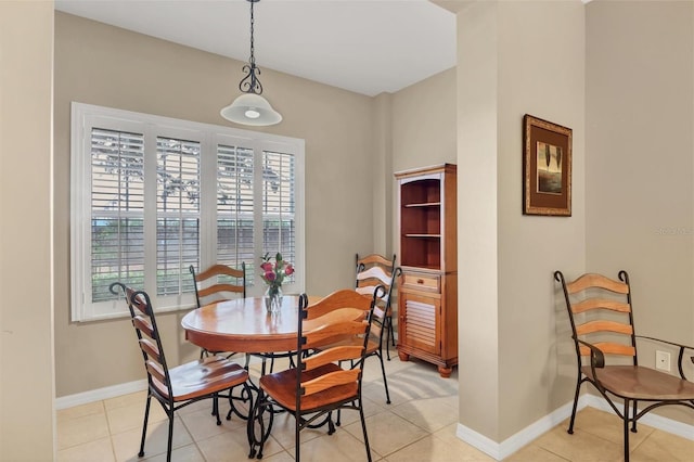 dining room featuring light tile patterned flooring and baseboards