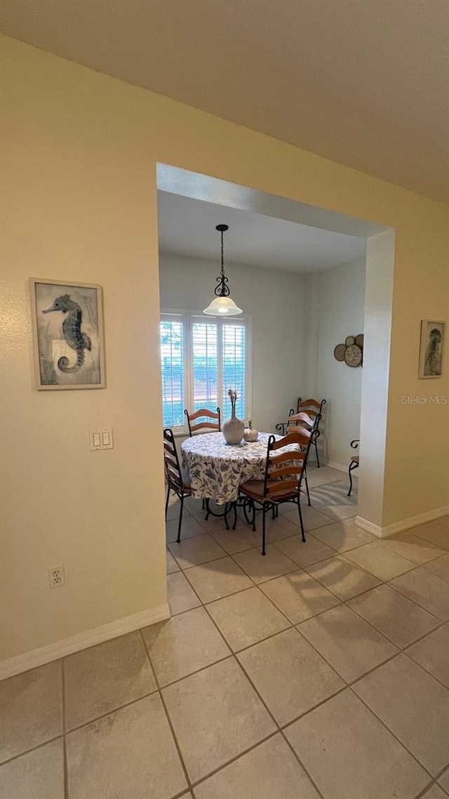 dining space with light tile patterned floors and baseboards