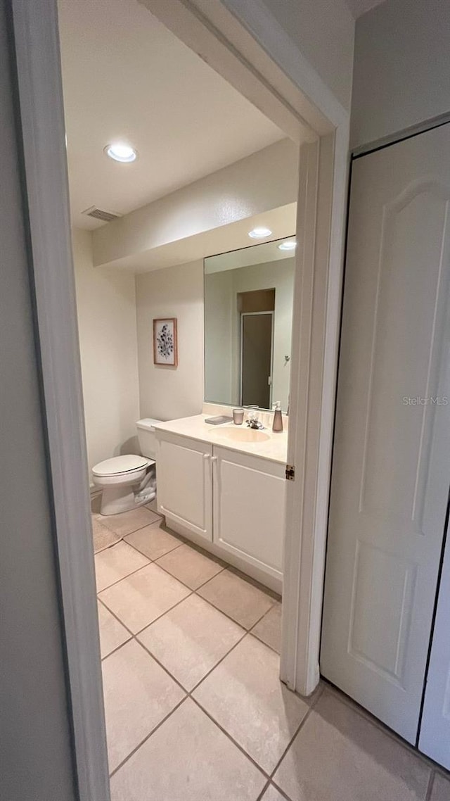 bathroom with visible vents, toilet, recessed lighting, tile patterned flooring, and vanity