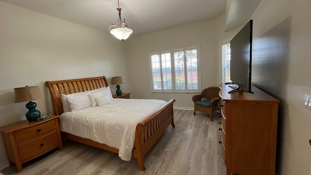 bedroom featuring light wood-type flooring and baseboards