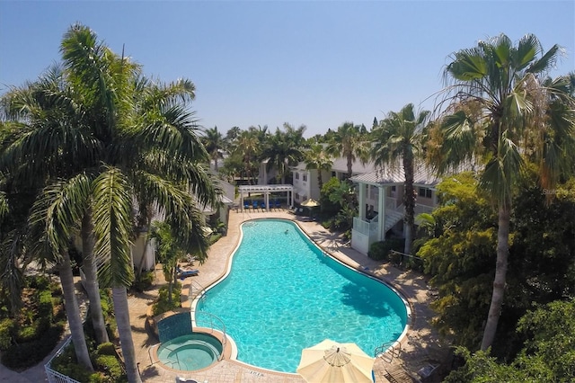 community pool featuring a patio area and a community hot tub